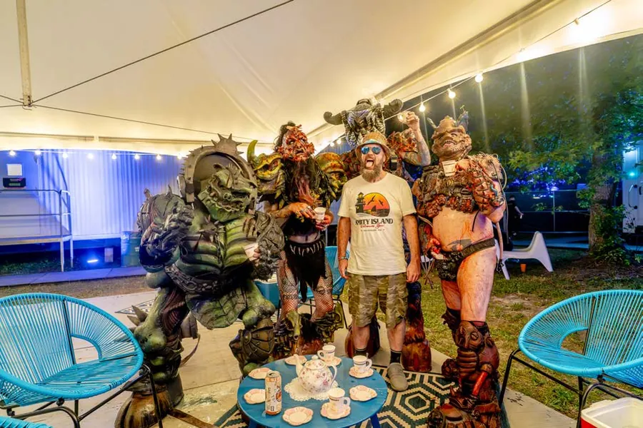 A Propeller winner raising a teacup with GWAR backstage at Bonnaroo
